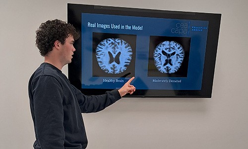 Finnbar Cooney, Data Analytics student, shows his research on Alzheimer's research
