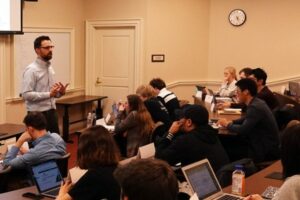economics classroom with students and professor presenting