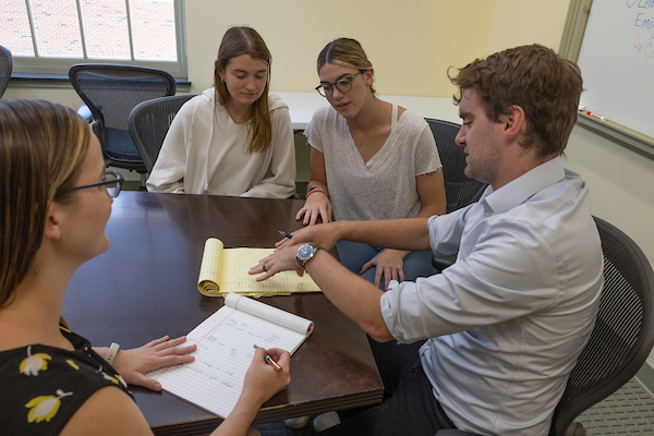 Group of students with professor Riley Acton