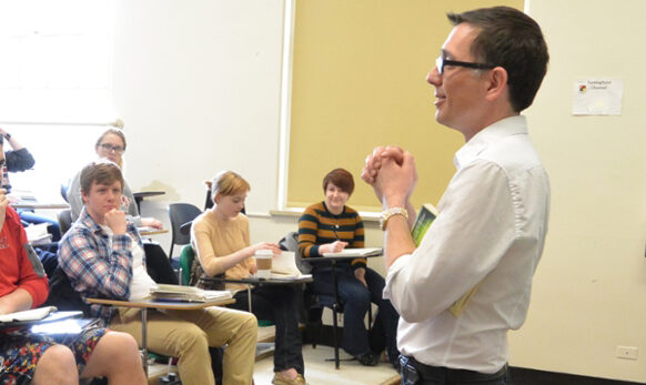 Students in class with Professor Jody Bates teaching