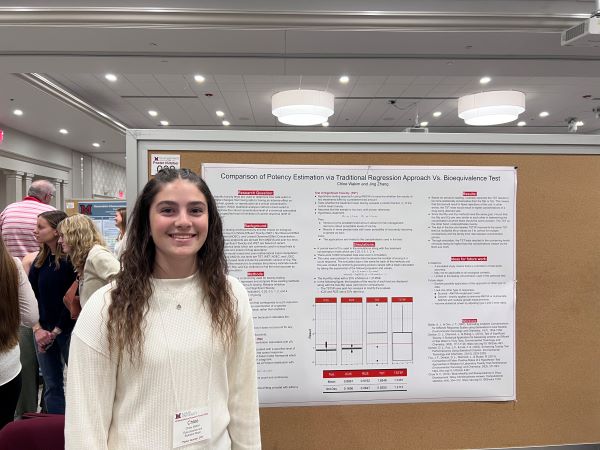 Statistics student posing at her poster session for the Undergraduate Research Forum