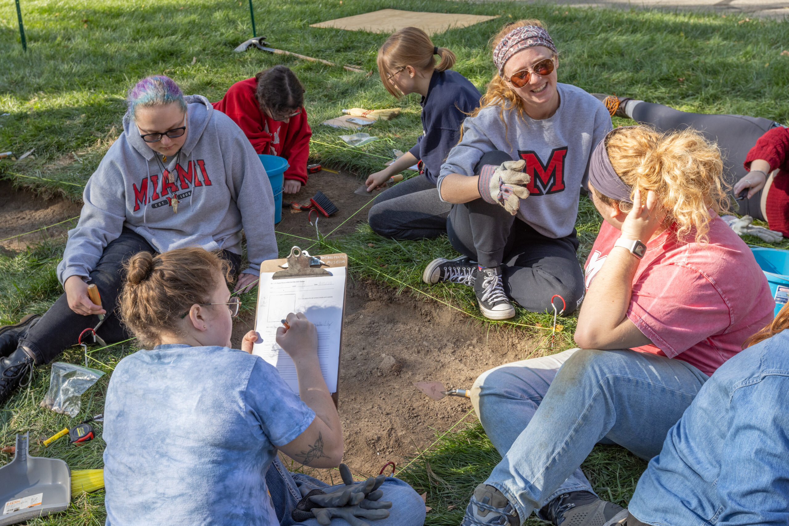 Anthropology students working outside during a field study.