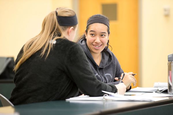 Two female students in a discussion in a Criminal Justice studies class