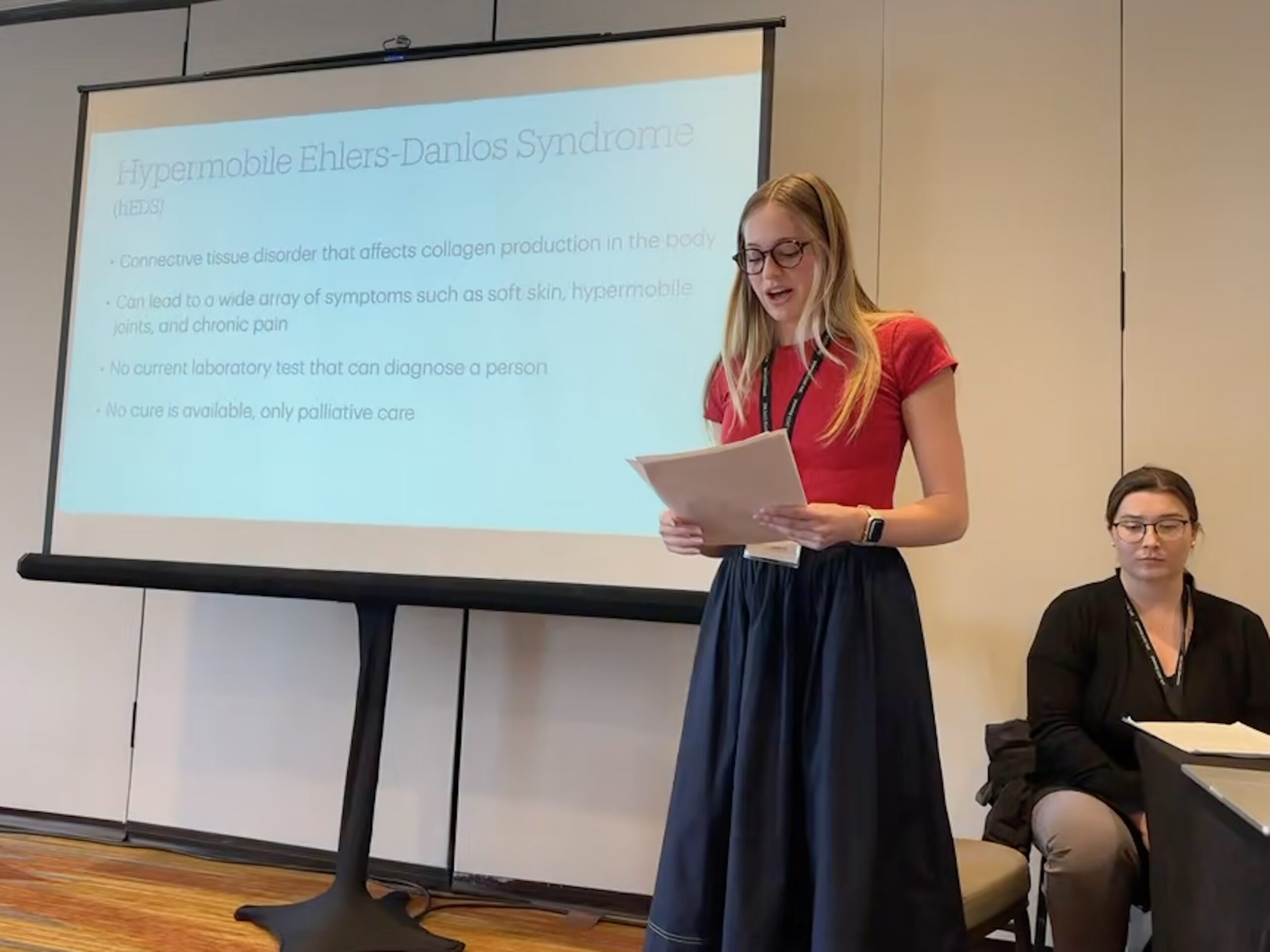 Global Health Student reading a paper at a conference