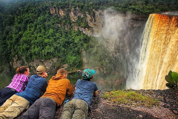 Students lay atop the world's largest single drop waterfall, Kaieteur Falls, in Guyana, South America.