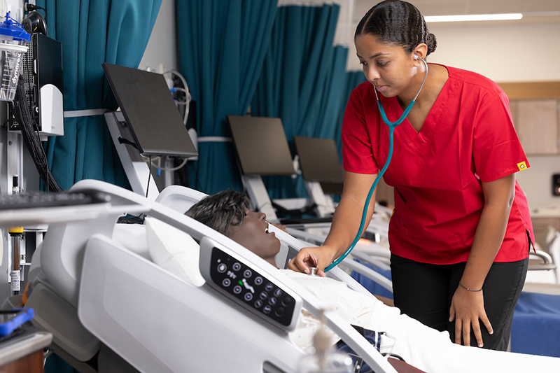 nursing student practicing on a dummy