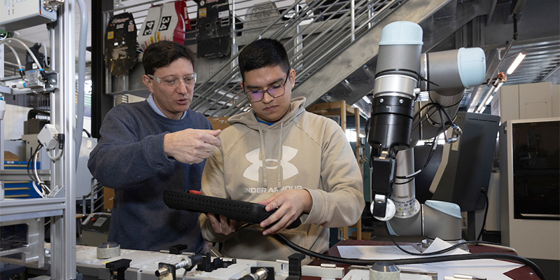 student and faculty member working on a manufacturing project