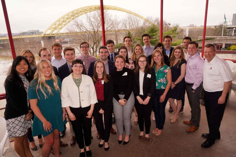 center for business leadership students and professor at event in cincinnati with bridge in background